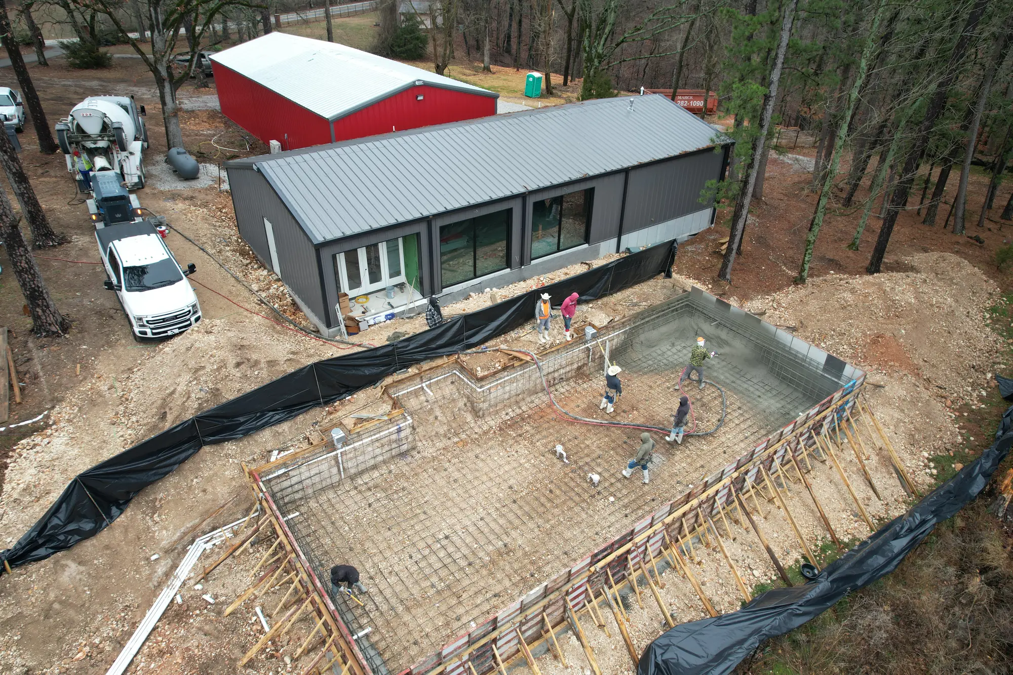 Aerial view of a pool shell and concrete pour in progress in Northwest Arkansas