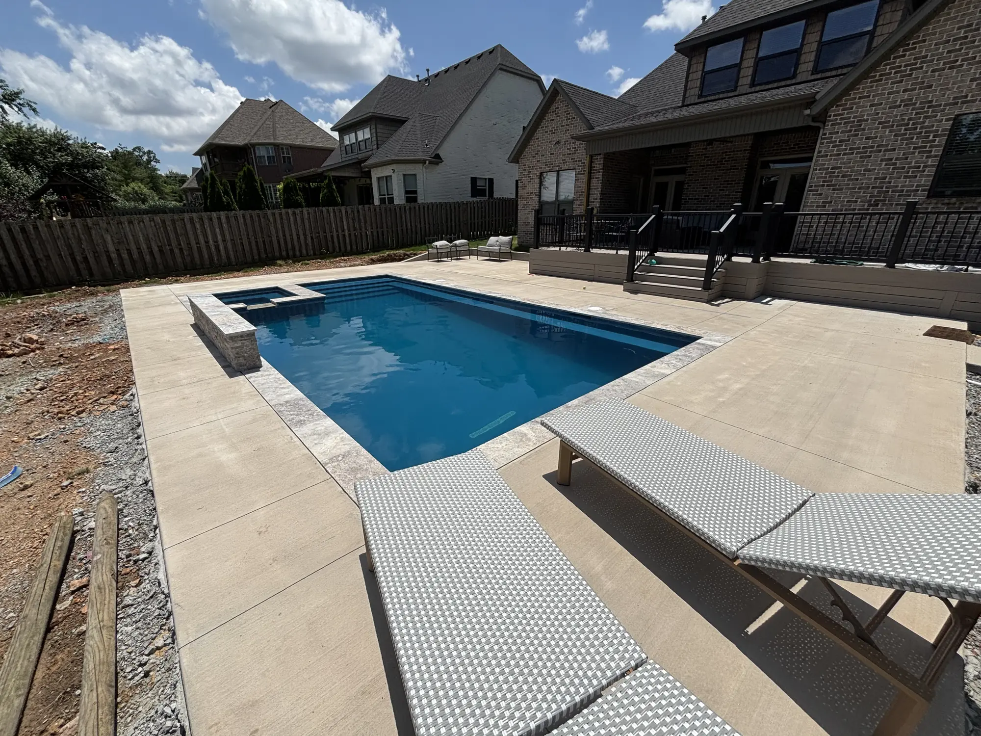 Backyard pool and spa with neighborhood view in Northwest Arkansas