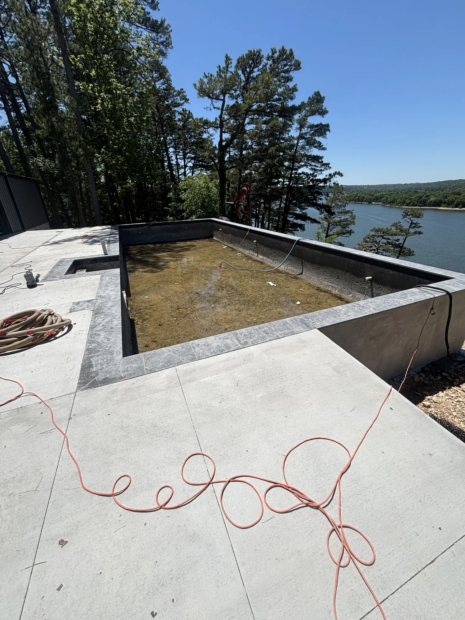 Cliffside pool with coping installed and lake views in Northwest Arkansas