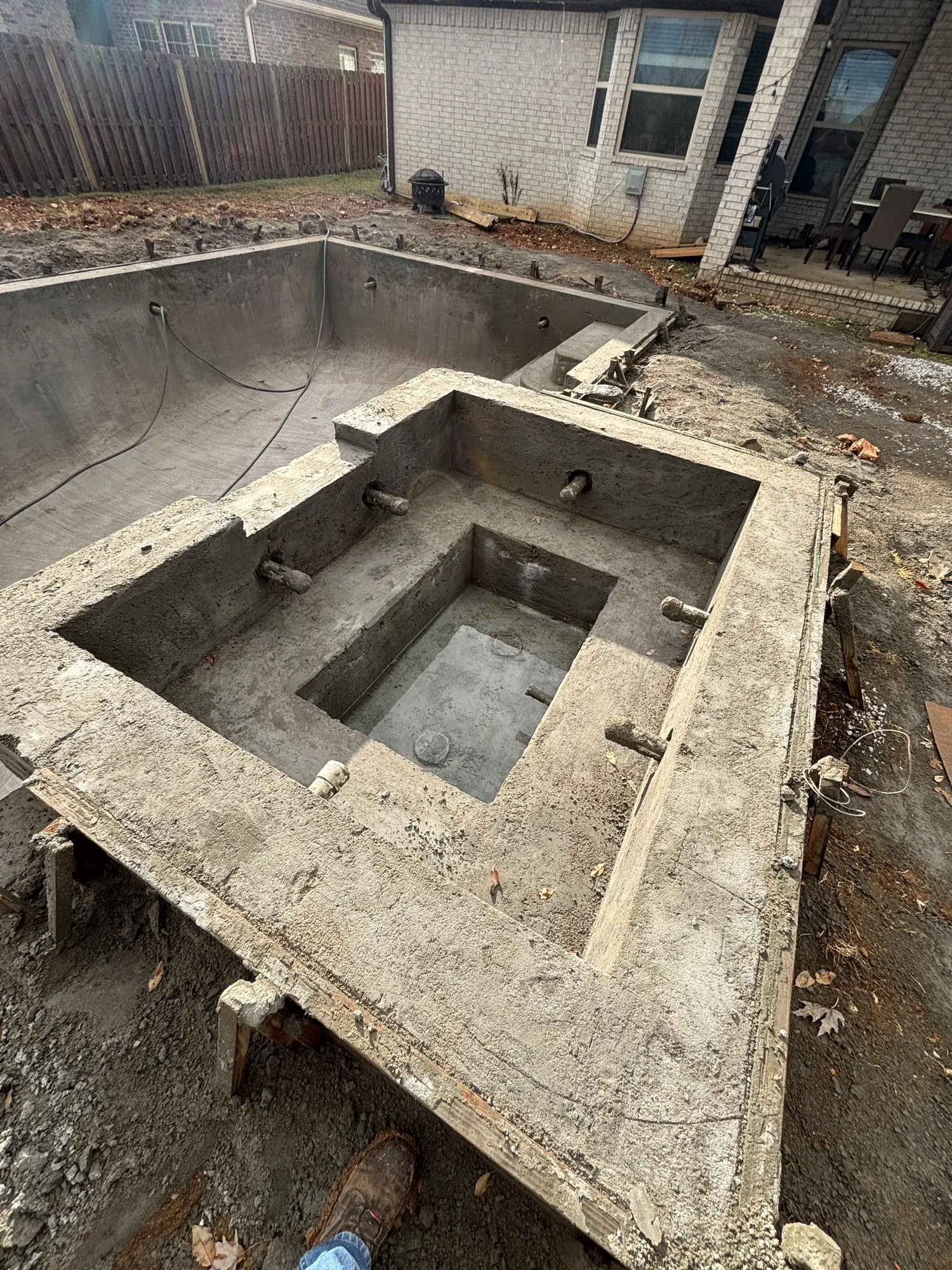 Concrete pool shell with raised spa in Northwest Arkansas