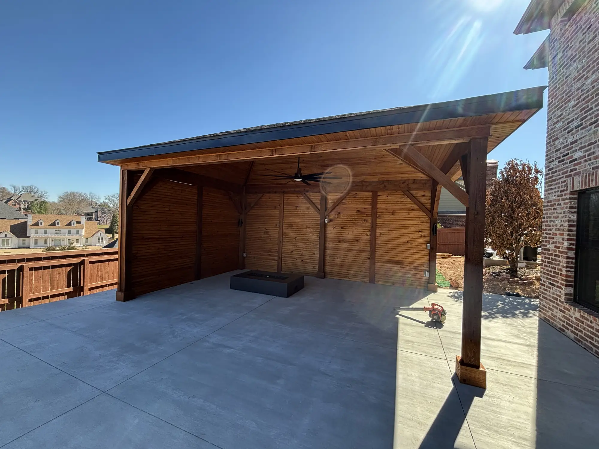 Covered outdoor living pavilion with fire pit in Northwest Arkansas