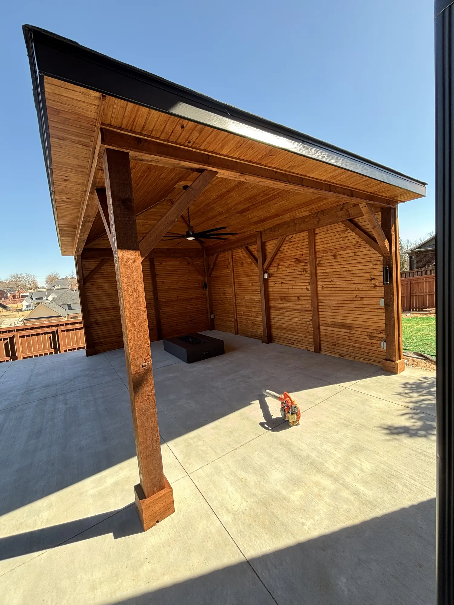 Covered outdoor pavilion with fire feature and ceiling fans in Northwest Arkansas