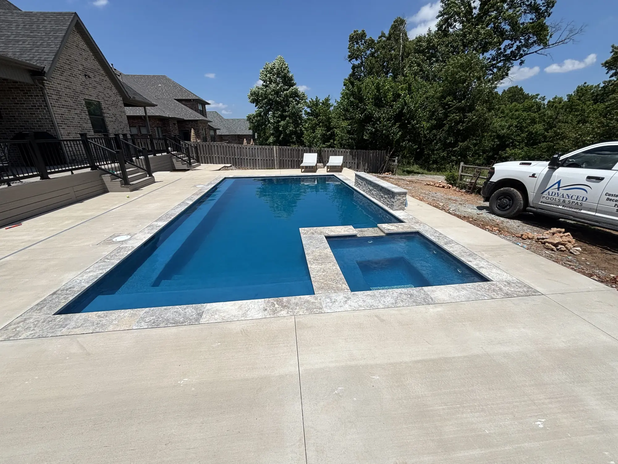 Custom pool and spa at a new brick home in Northwest Arkansas