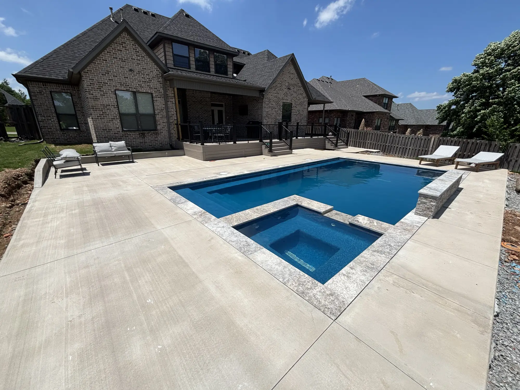 Finished custom pool and spa in a Northwest Arkansas backyard at a brick home