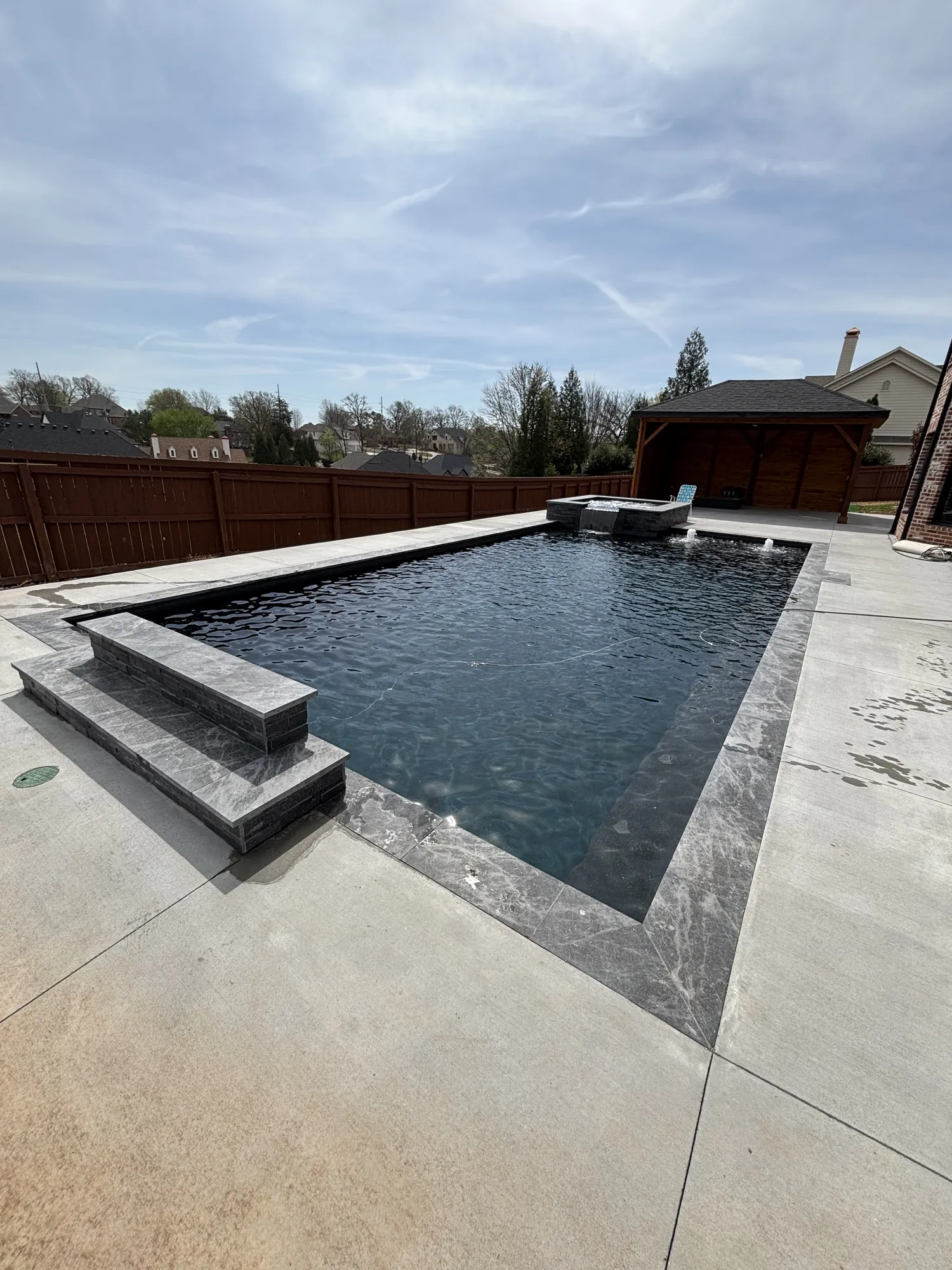 Custom pool with attached pergola pavilion in Northwest Arkansas