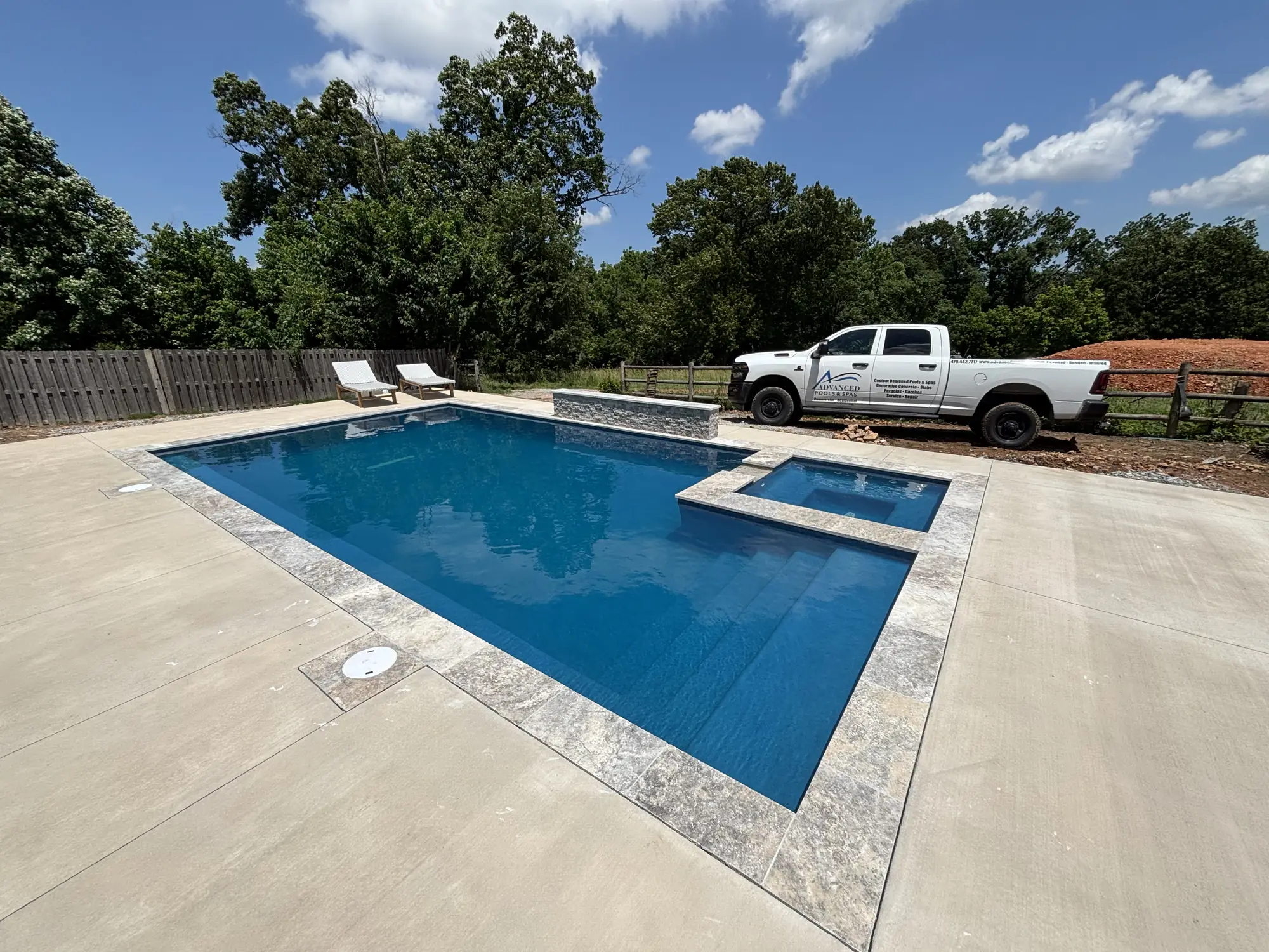 Saltwater pool and raised spa with poolside loungers in Northwest Arkansas