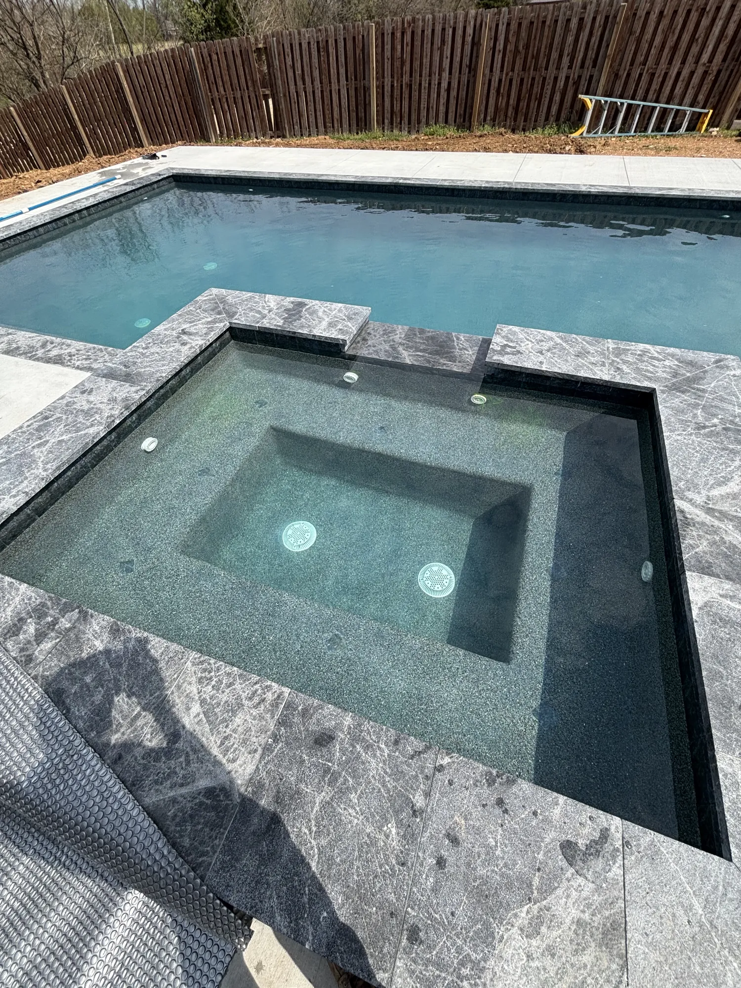 Finished raised spa with marble surround in Northwest Arkansas