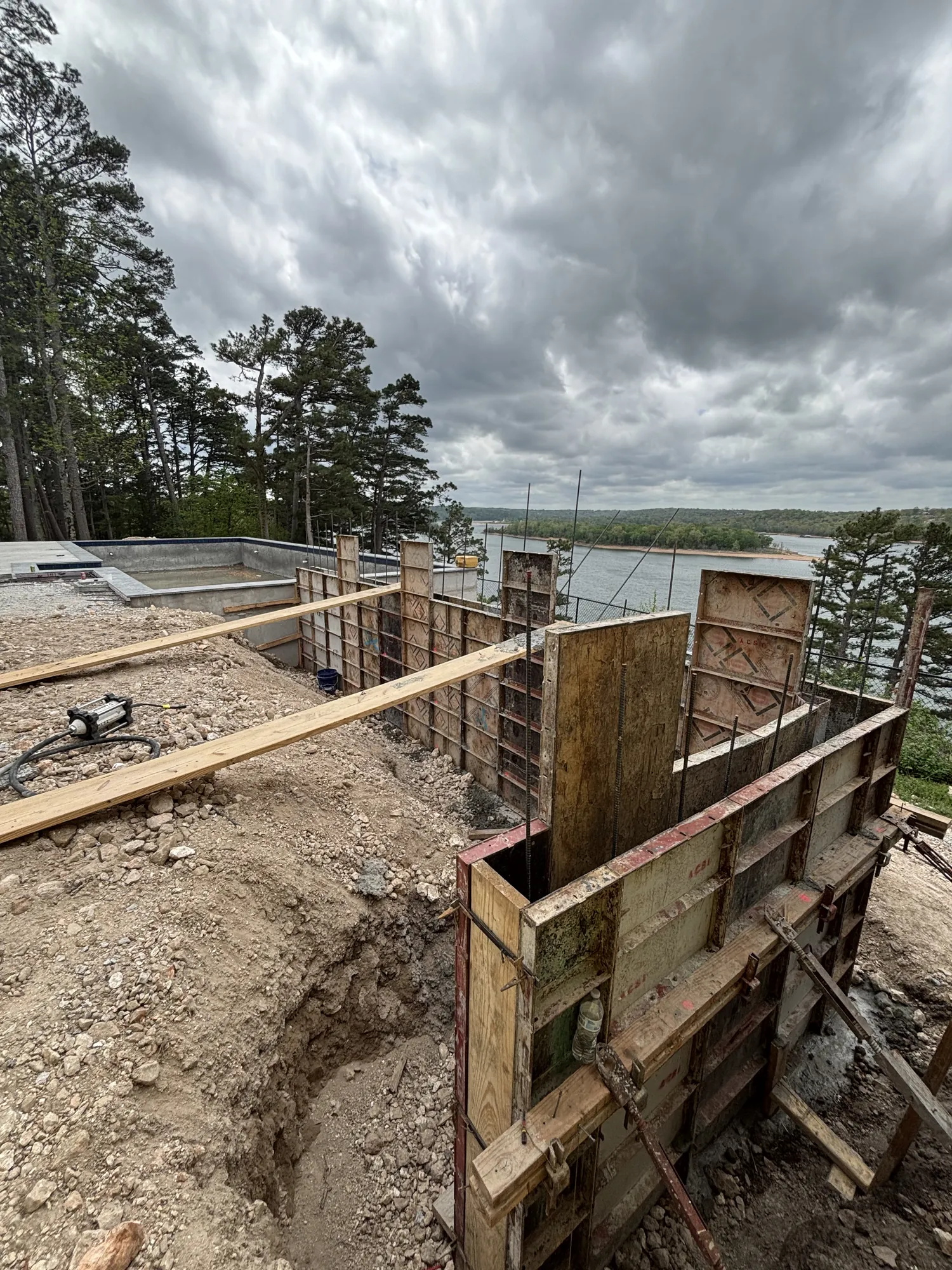 Retaining wall construction at lakeside pool in Northwest Arkansas
