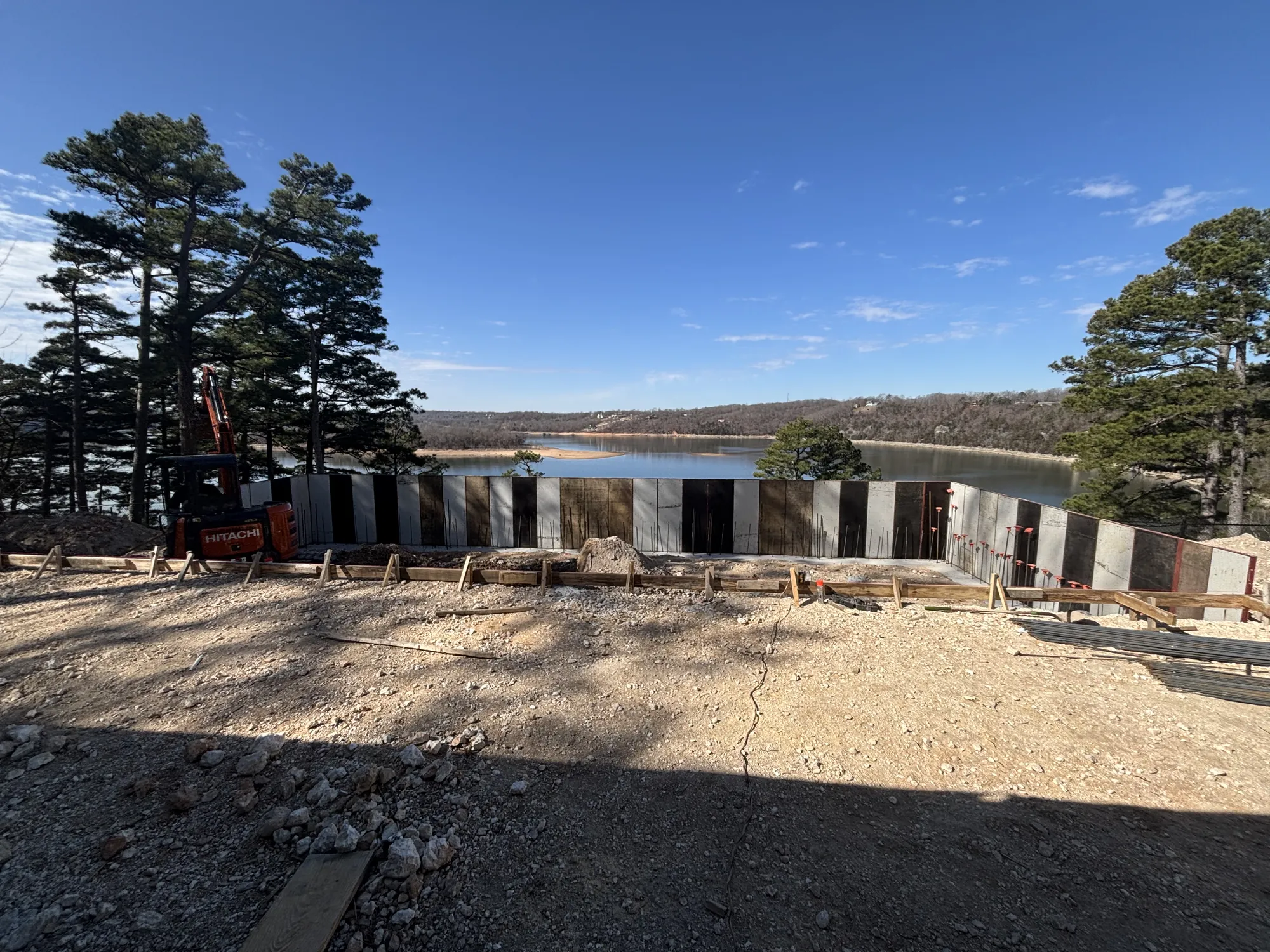 Pool walls under construction with lake panorama in Northwest Arkansas