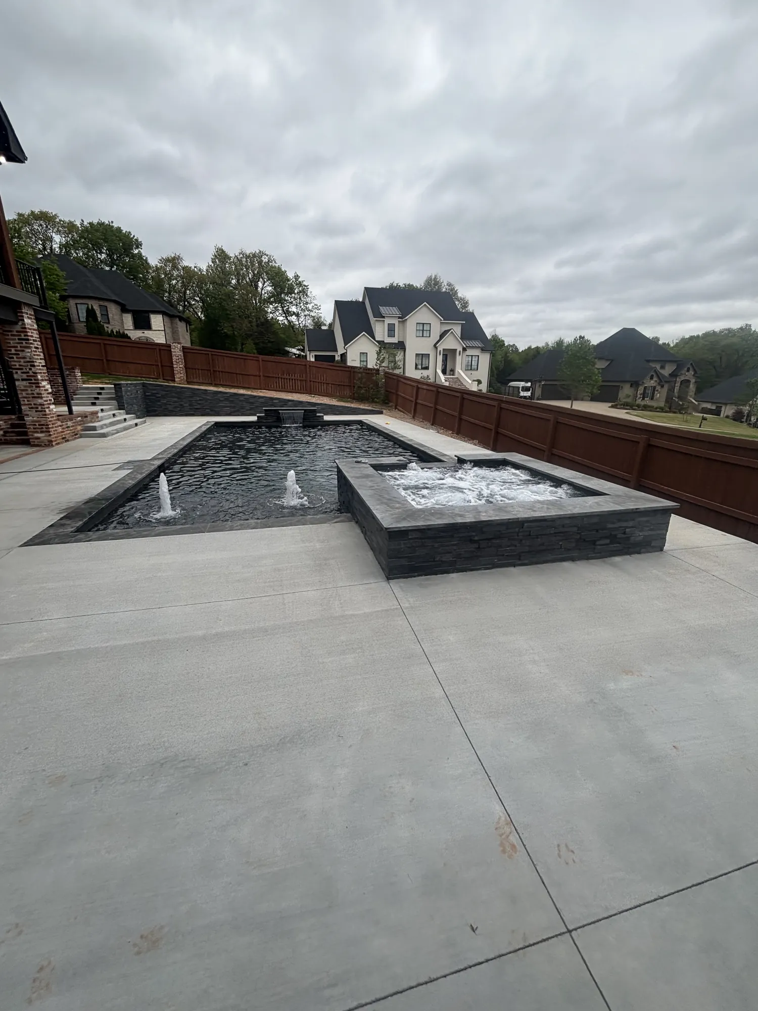 Pool and raised spa with bubbler water features in Northwest Arkansas