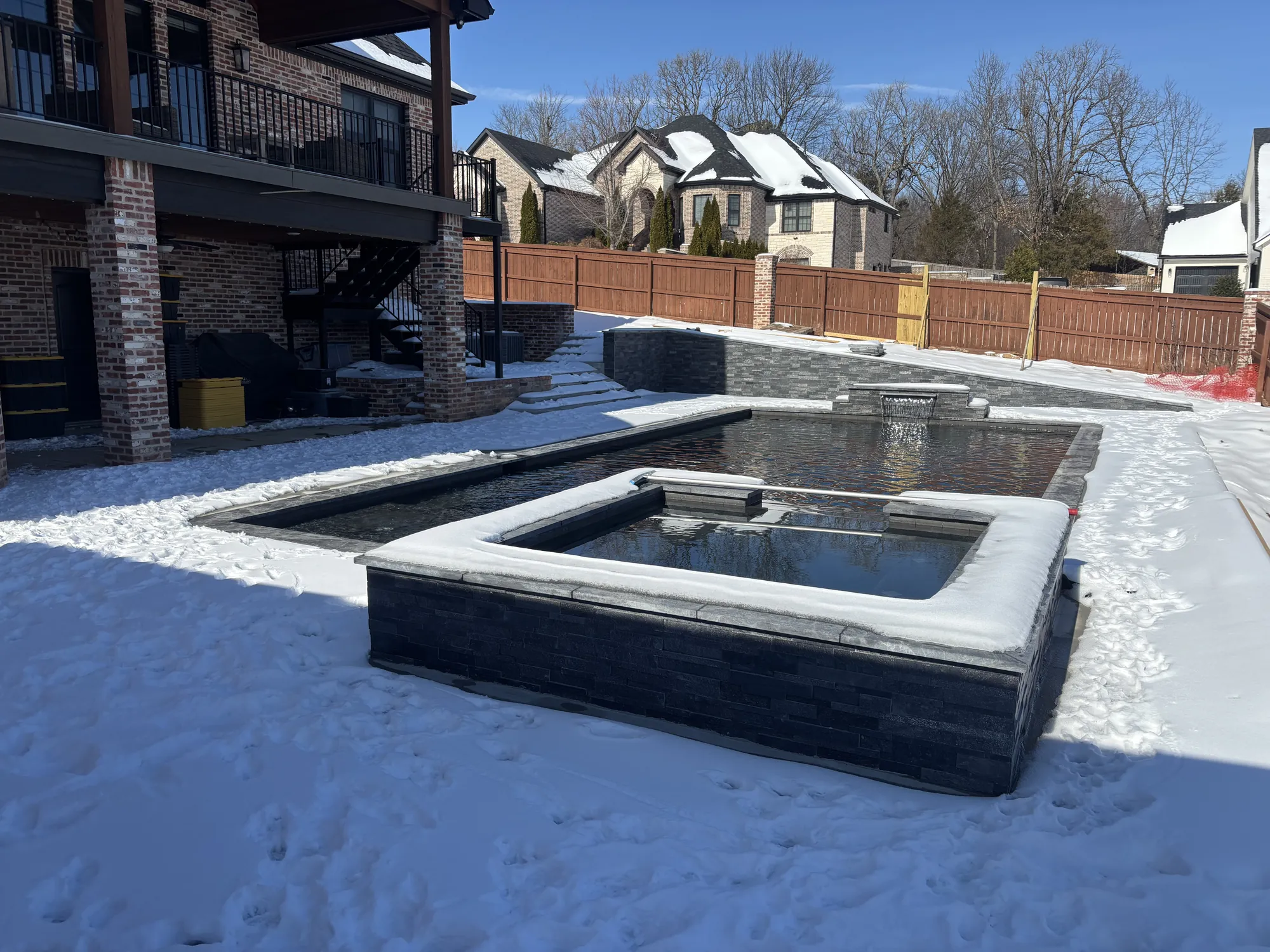 Pool and spa under winter snow in Northwest Arkansas