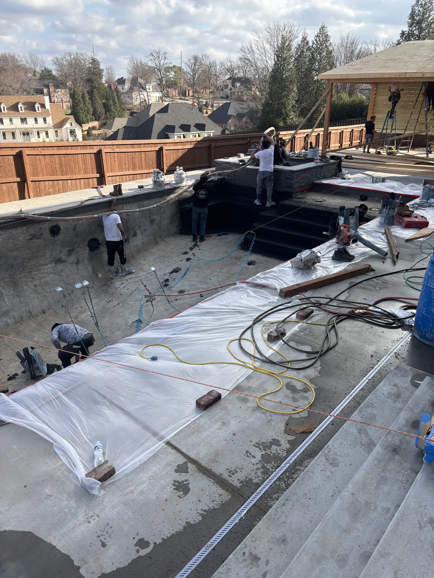 Crew installing pool finish in Northwest Arkansas