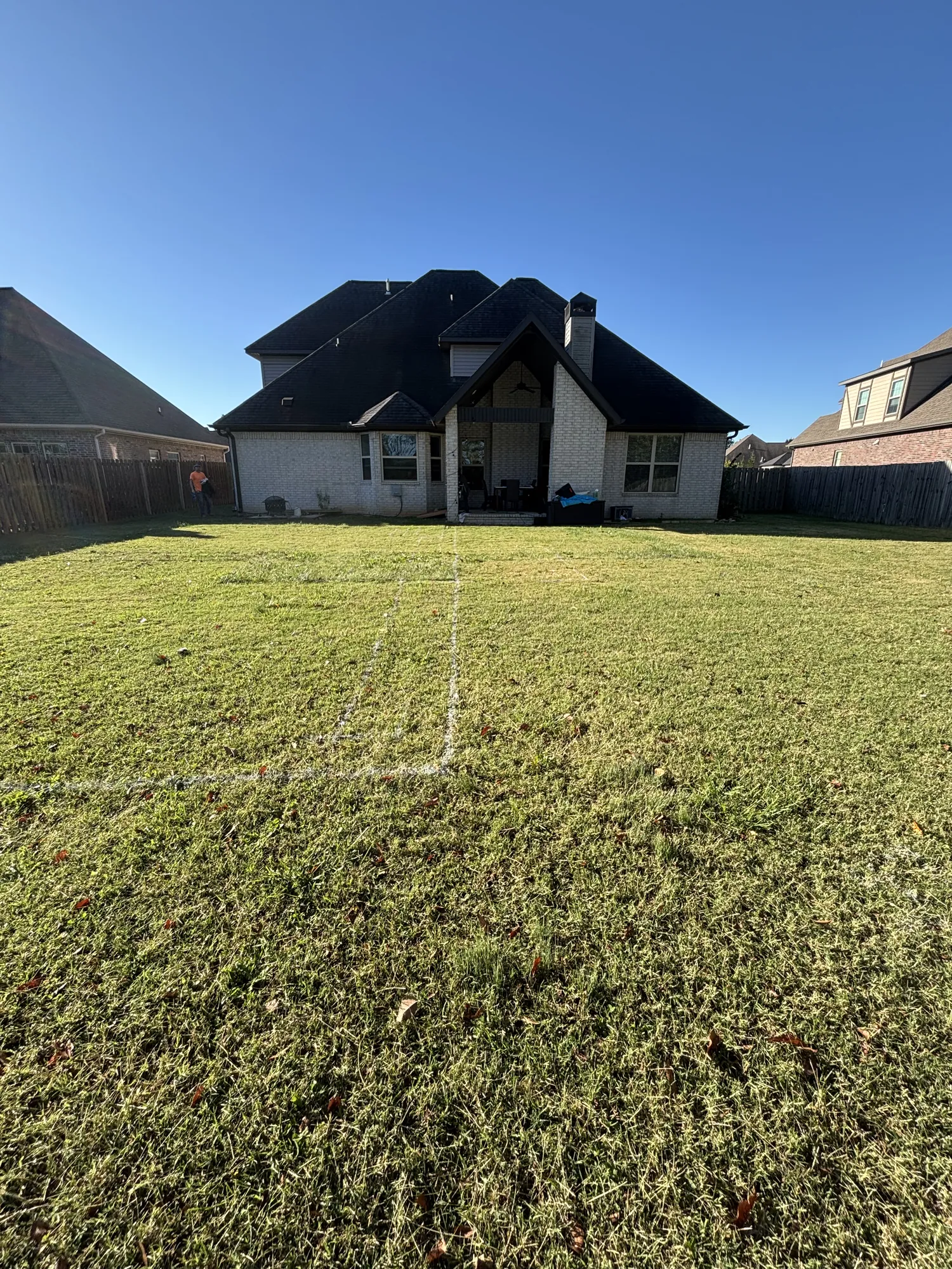 Pool footprint staked out on lawn in Northwest Arkansas