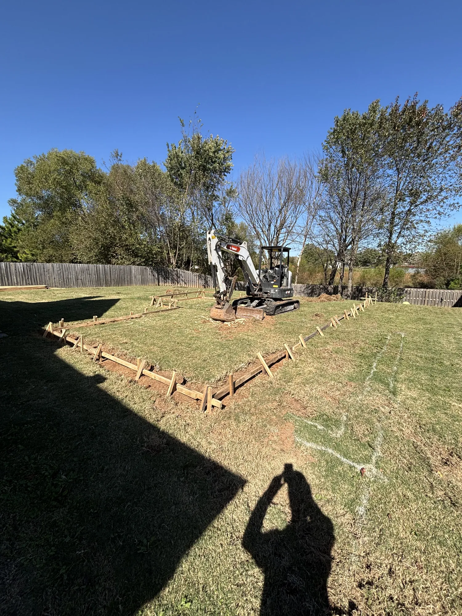 Pool site with excavator staged for build in Northwest Arkansas