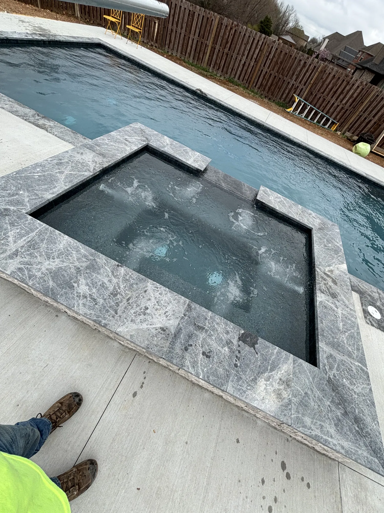 Raised spa with marble coping detail in Northwest Arkansas