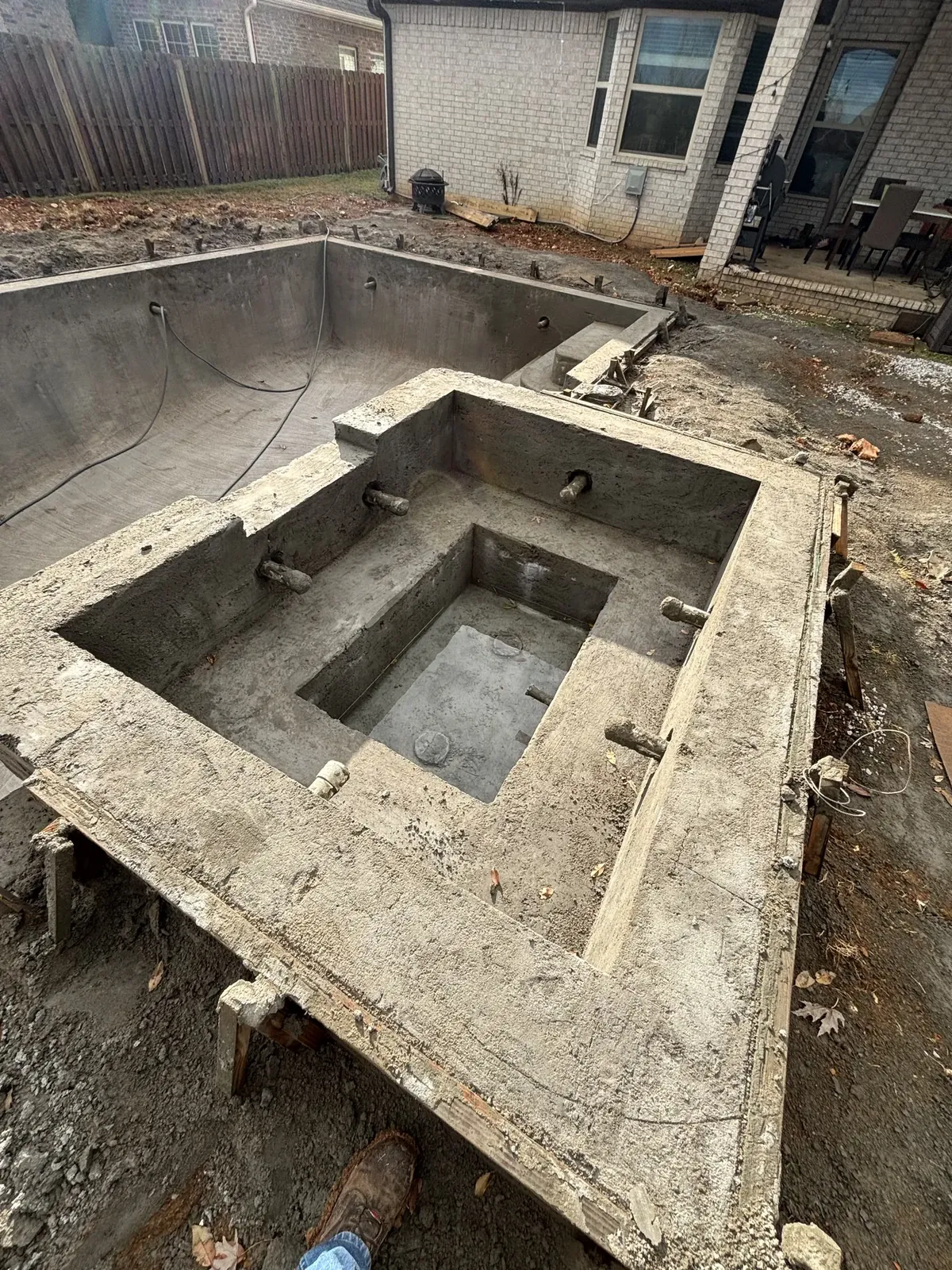 Concrete pool shell with raised spa in Northwest Arkansas