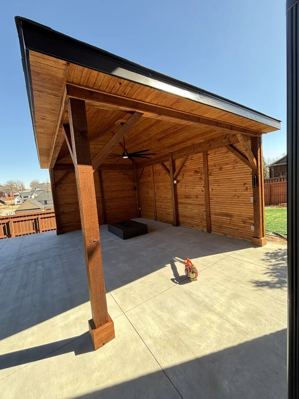 Covered outdoor pavilion with fire feature and ceiling fans in Northwest Arkansas