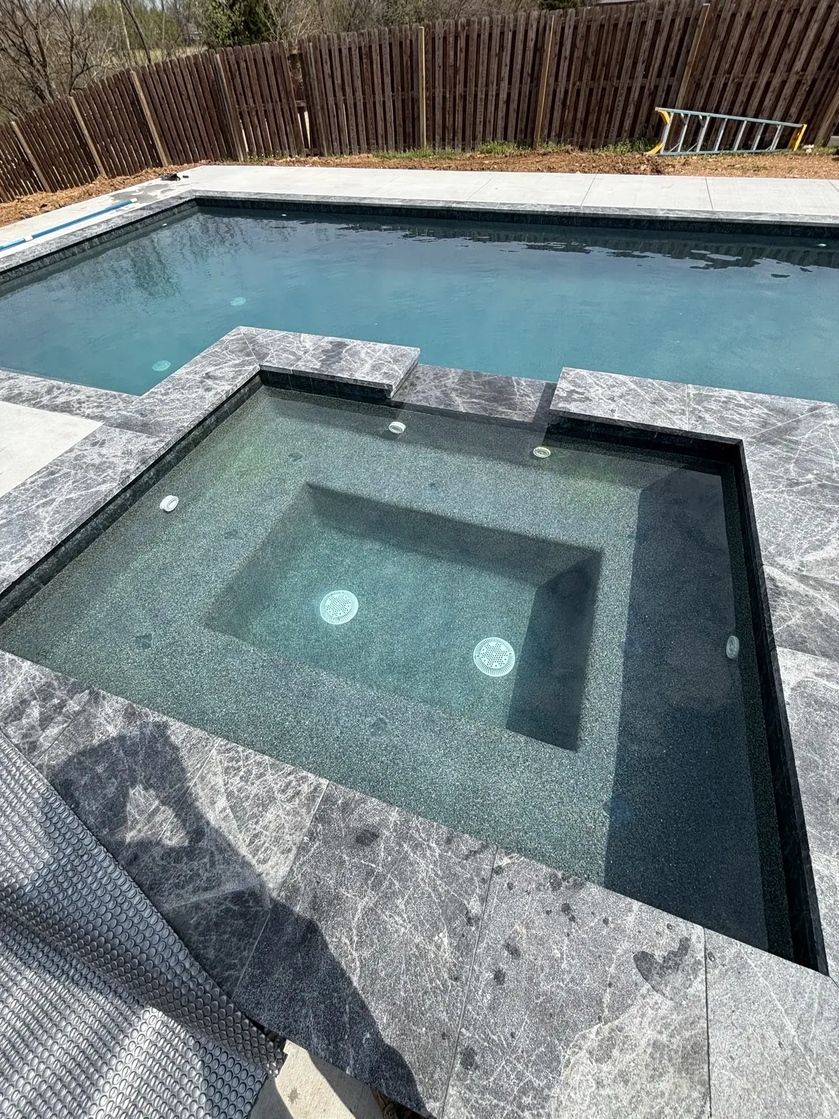 Finished raised spa with marble surround in Northwest Arkansas