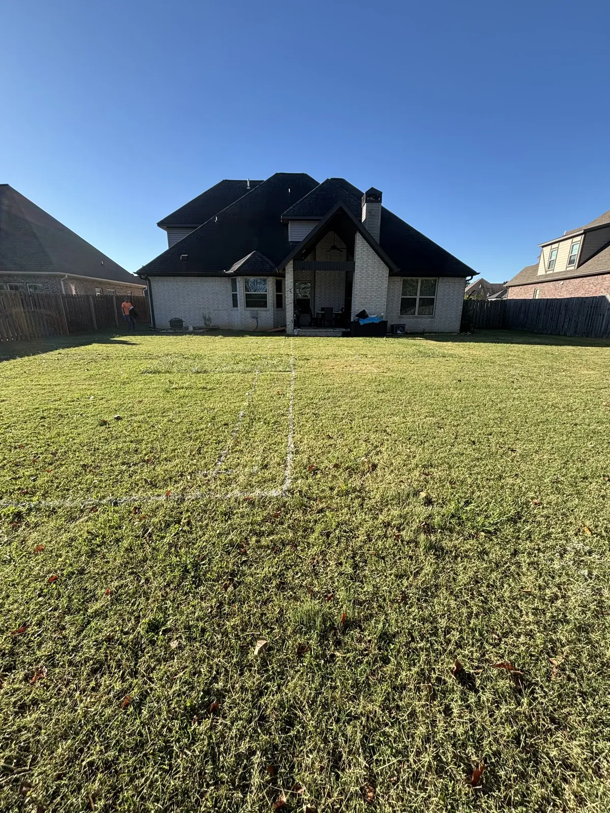 Pool footprint staked out on lawn in Northwest Arkansas