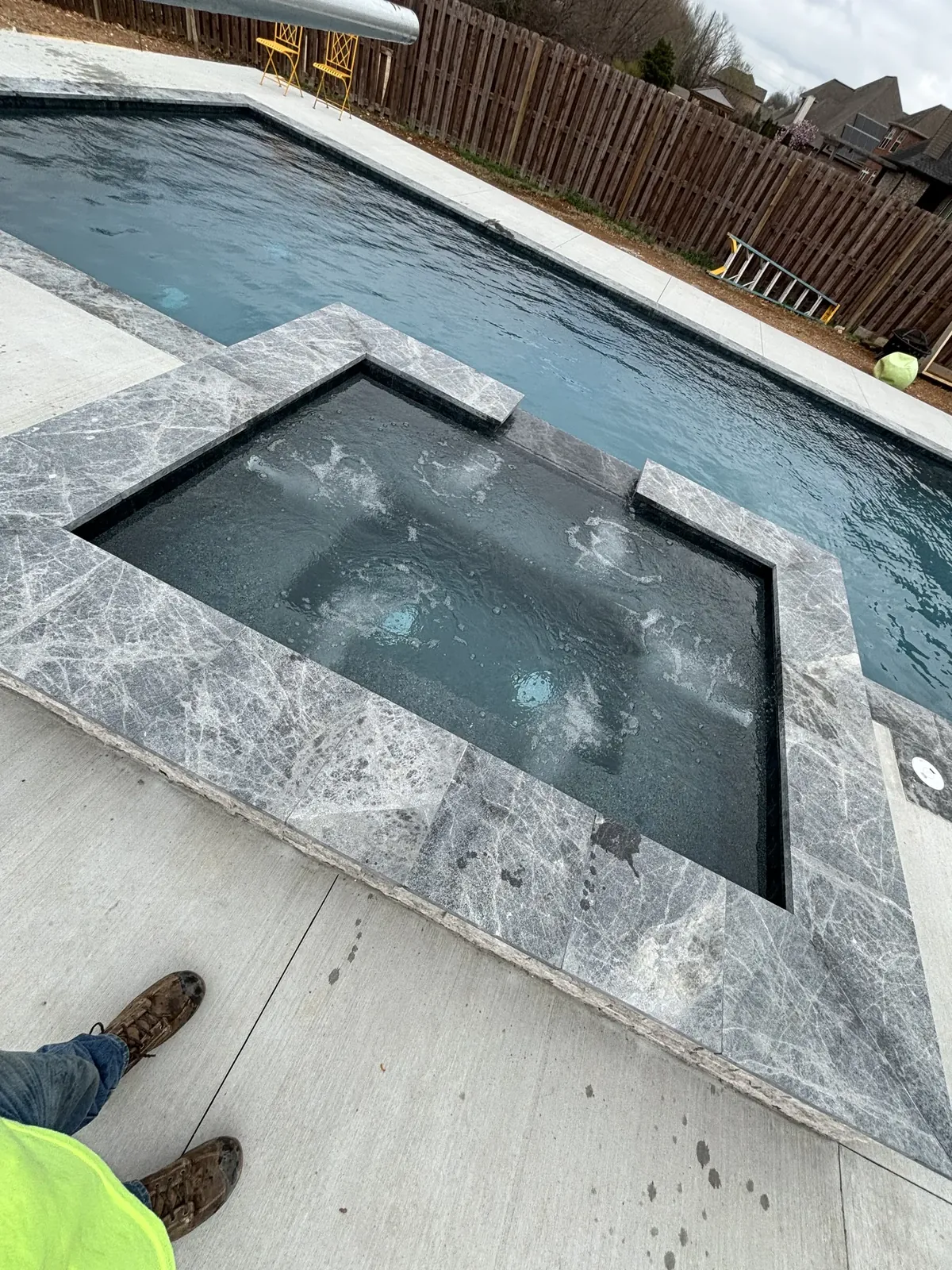 Raised spa with marble coping detail in Northwest Arkansas